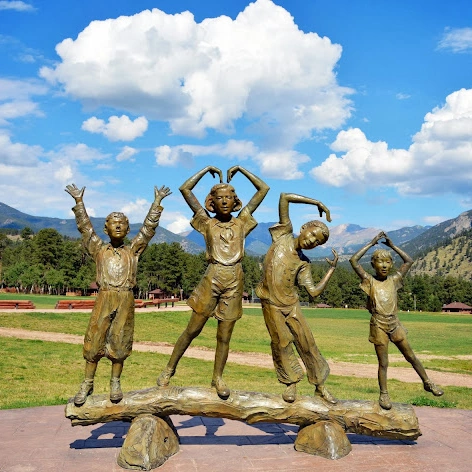 Kids Form The Letters Ymca Bronze Statue with Their Arms